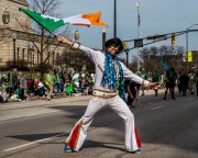 Images from downtown Indy's St. Patrick's day parade - elvis impersonator holding a flag