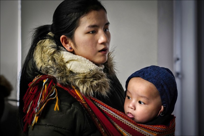 Chin Refugees of Indianapolis

Using a traditional Southeast Asian baby carriage, Chin refugee Tail Lang-Mon waits with her infant Abust Peng Baceli for assistance at the Indiana Chin Center in the Indianapolis neighborhood of Southport.