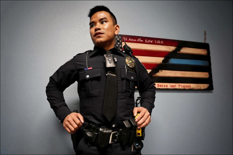 Chin Refugees of Indianapolis
Southport, Indiana, volunteer police officer Bawi Lian prepared discusses a felony arrest.  He is a Burmese Chin refugee who came to the United Statess as a teenager.