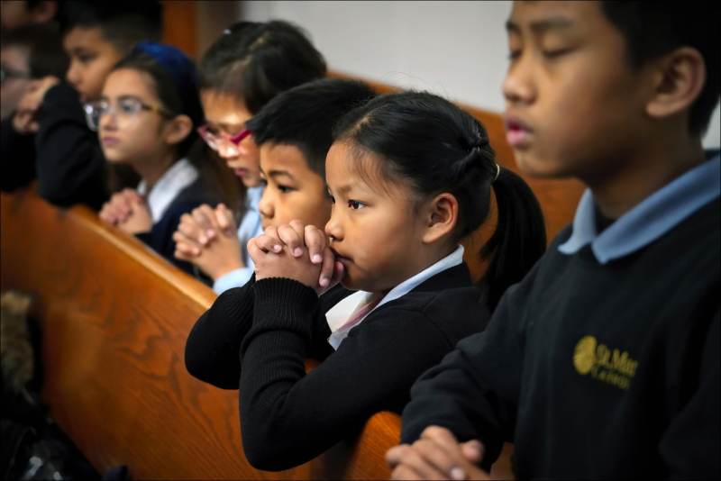 Chin Refugees of Indianapolis
Children of Burmese Chin descent pray during the Mass at St. Mark Catholic Church in suburban Indianapolis.