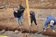 Mina helping to pour the foundation of the house. Renovated by Mina & Karen; as seen on Good Bones Season 7