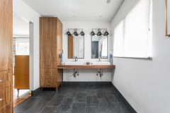 In this master bath, Derek can wheel his chair right under the countertops and see into the low-hung mirrors.