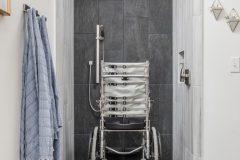 The shower is wide enough for Derek’s wheelchair, and the flooring soaks up enough water to provide traction.