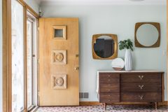 Two mirrors, lucky finds at Target, blend right into the woodwork of the 1952 home, which the Lavenders dubbed “The Quarry” for the limestone it’s clad in. The foyer’s tile is original to the house.