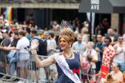 A Bag Lady sits and wave Photos from Indy Pride Parade 2022