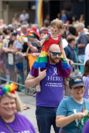 a dad hold a child in Photos from Indy Pride Parade 2022