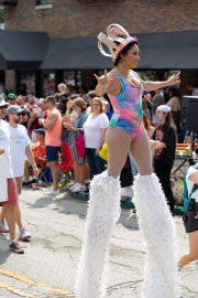 a woman on stilts marches in this Photo from Indy Pride Parade 2022