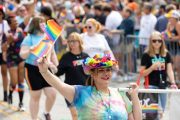 a person waving a flag marching Photos from Indy Pride Parade 2022