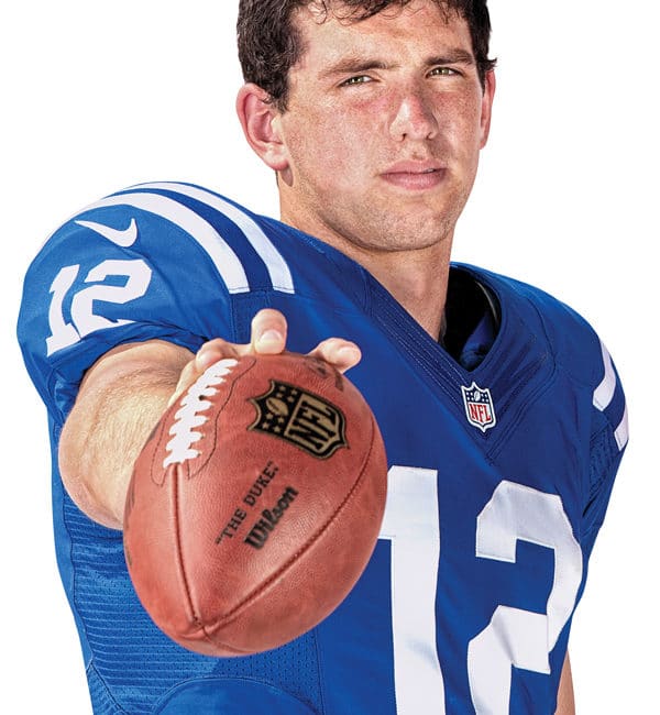 Andrew Luck with a football looking at camera