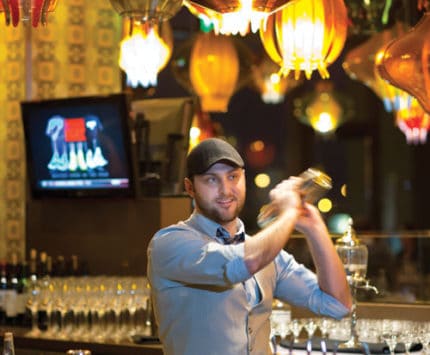 Plat 99 general manager Michael Gray mixes up a concoction in the trendy bar.