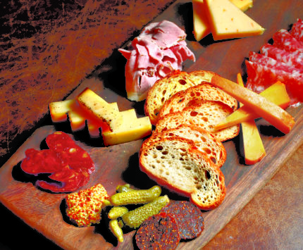 Charcuterie choices ranging from mortadella to vegan fig "salami"