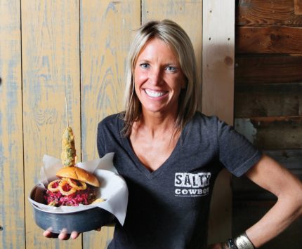 Owner Shari Jenkins with The Big Hughey burger.