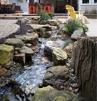 A recirculating, man-made creek flows between the patio and pool areas.