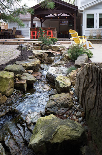 A recirculating, man-made creek flows between the patio and pool areas.