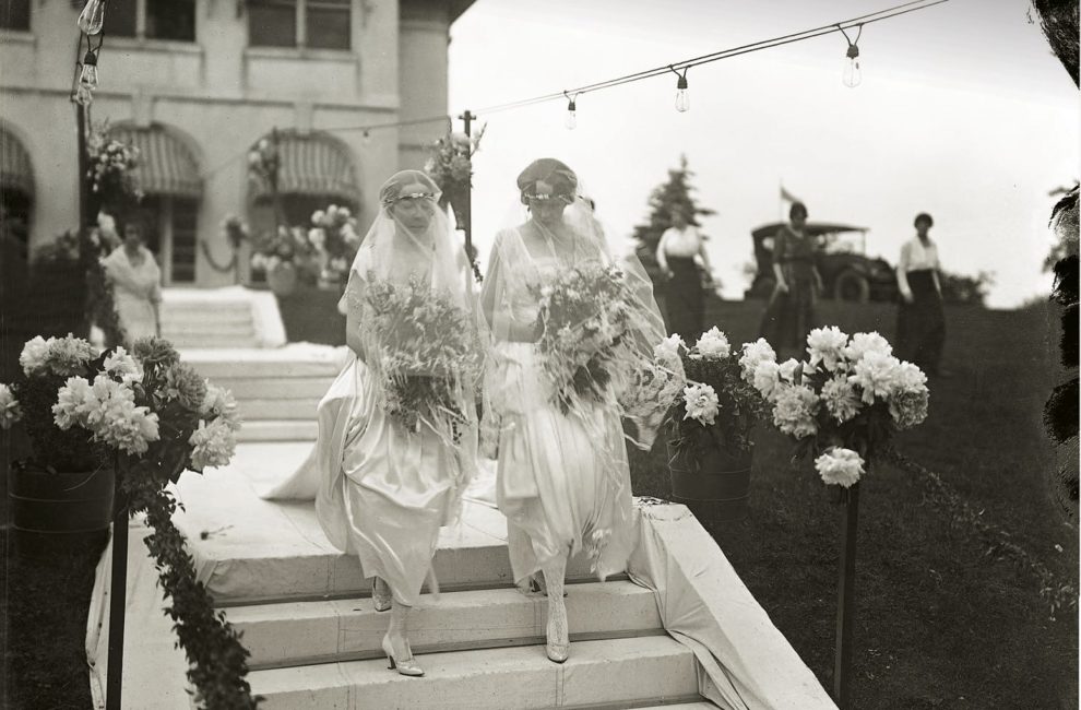 As seen on brides (and sisters) Alice and Margaret Landon, the dress length of the day revealed ankles in decorative silk stockings above bejeweled satin heels.