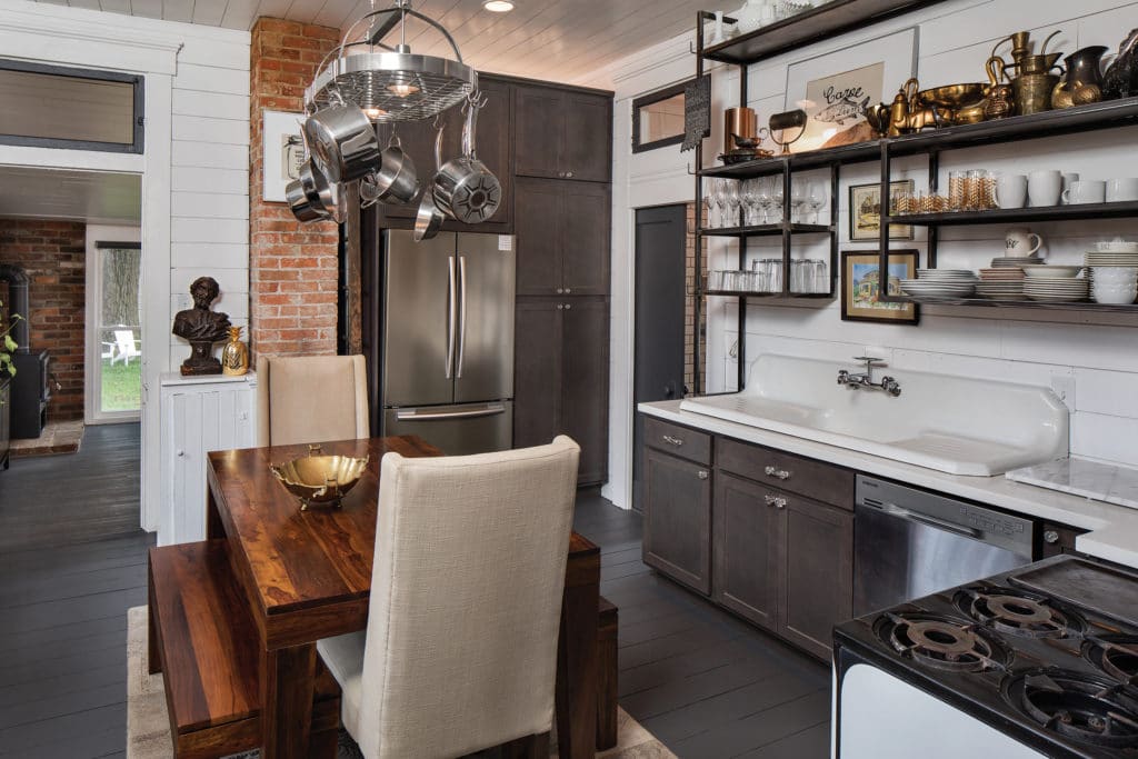 Kitchen with white wood walls (shiplap) and vintage stove.