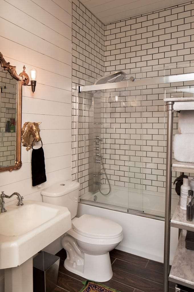 Small bathroom with white tile to ceiling.