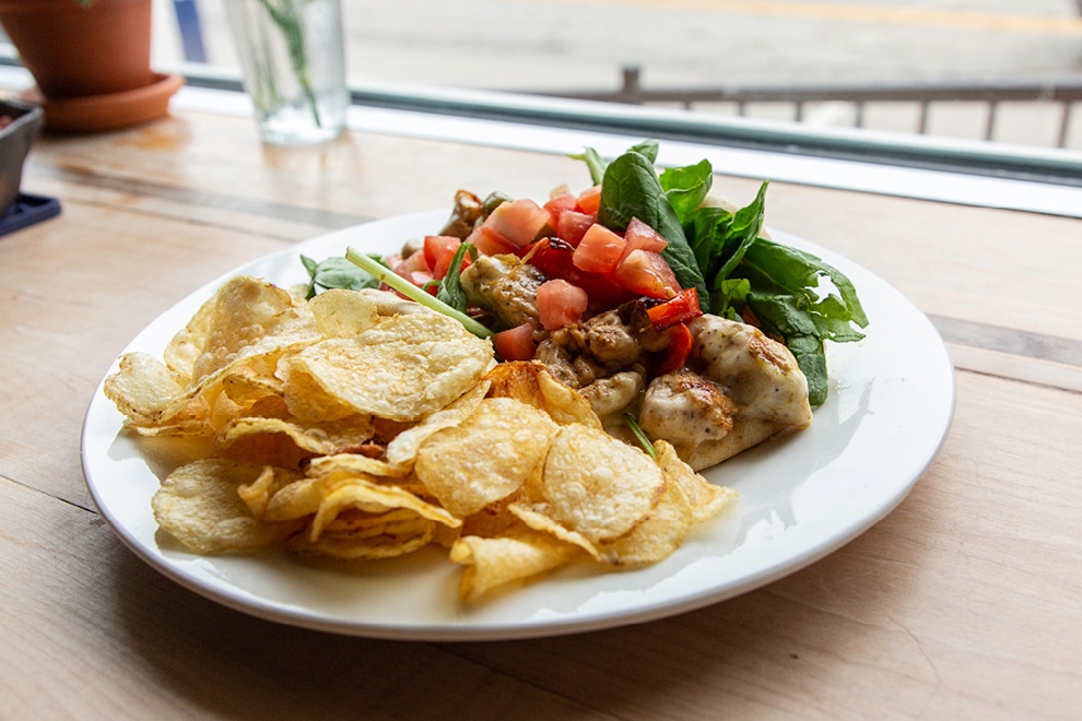 Chicken with greens and chips at SoBro Cafe