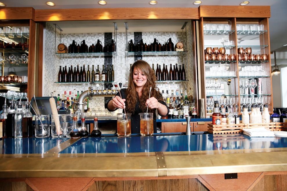 Bartender mixing cocktails at the bar at Spoke & Steele