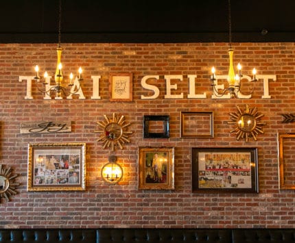 Thai Select interior gallery wall on brick