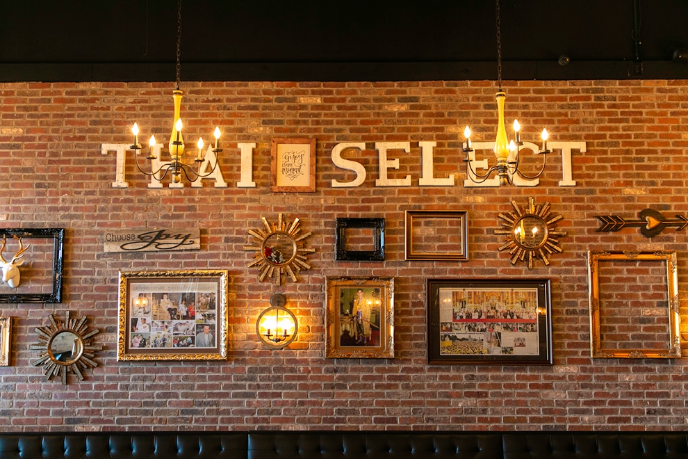 Thai Select interior gallery wall on brick