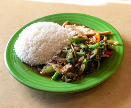 Thai stir fry with white rice on green plate from Thai Spice