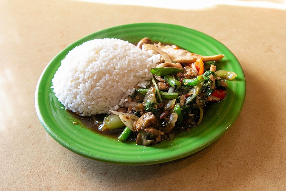 Thai stir fry with white rice on green plate from Thai Spice