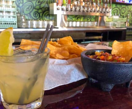 Condado chips and salsa and margarita at bar