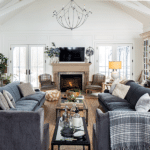 An arched white room with comfortable couches and chairs.