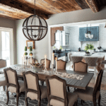 A darker dining room with a large table and light fixture hangs overhead.