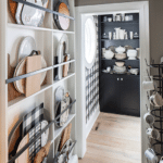 A tucked away pantry closet with dishware.