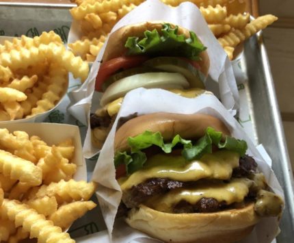 A tray of cheeseburgers and fries