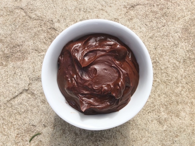 A bowl of thick, dark, gooey chocolate.