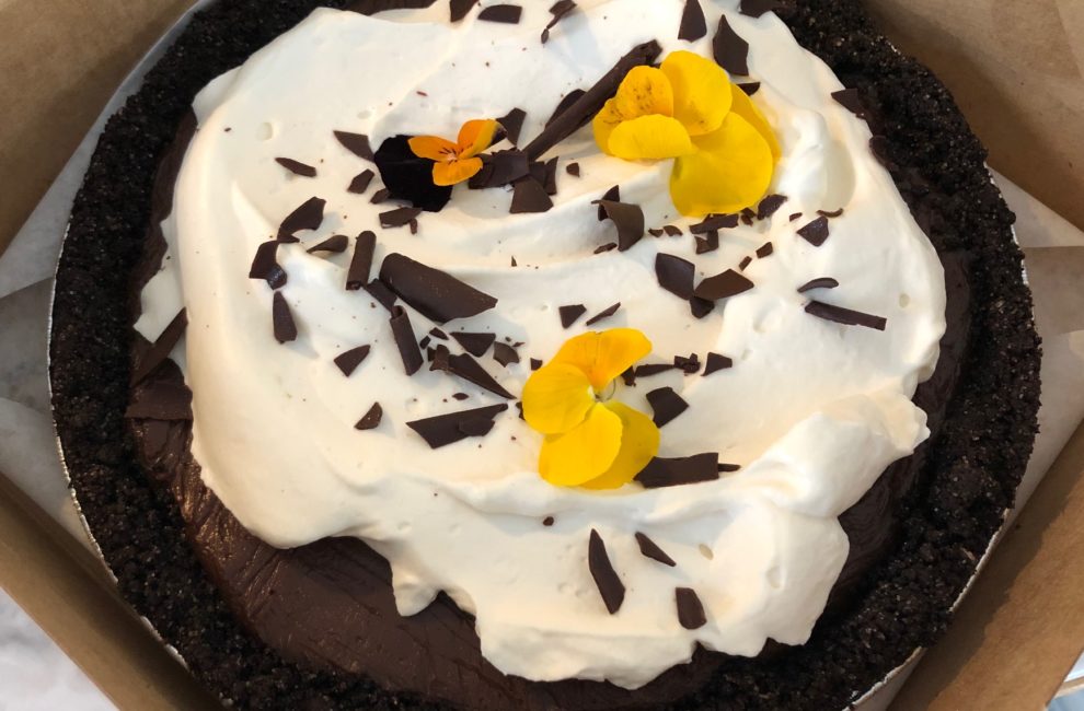 A decadently delicious chocolate pie topped with whipped cream and chocolate shavings.