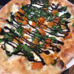 Winter squash, spinach, mozzarella, and balsamic drizzle top a pizza