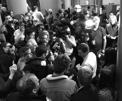 Reporters surround presidential candidate Pete Buttigieg.