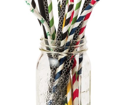 A mason jar full of multicolored paper straws