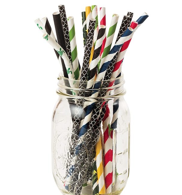 A mason jar full of multicolored paper straws