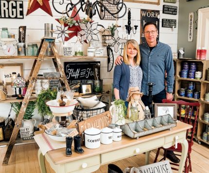 A couple stands inside a vintage goods store.