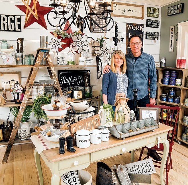 A couple stands inside a vintage goods store.