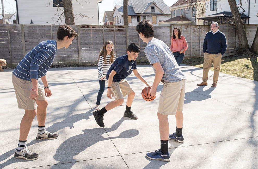 A family plays backyard basketball.