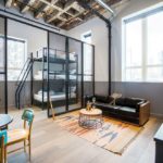 A boutique hotel room suite bathed in light.