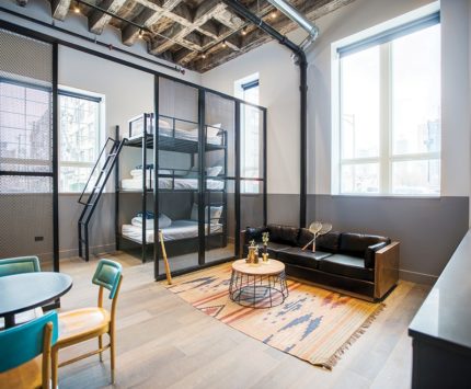 A boutique hotel room suite bathed in light.