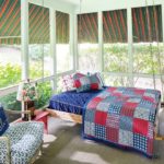 A screened-in porch features a swinging bed.