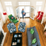 An overhead shot of a bright living room with colorful seating.