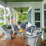 Blue and white furniture line a large front porch.