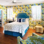 A bedroom decorated in yellow and blue patterns.