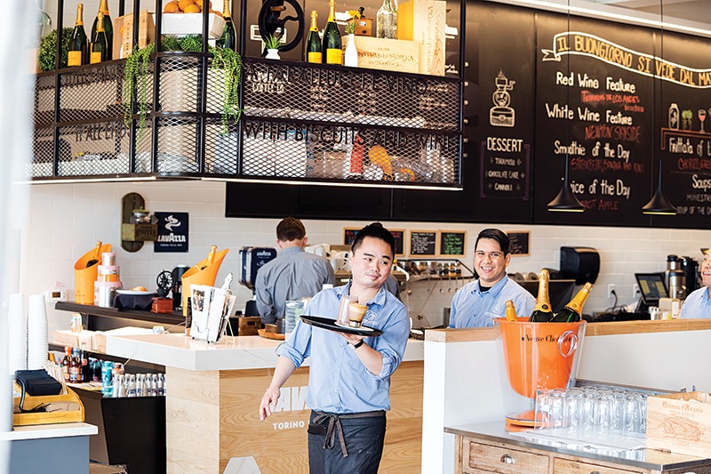 A busy, but brightly decorated coffee shop.