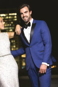 Blue tuxedo on male model with bride on left