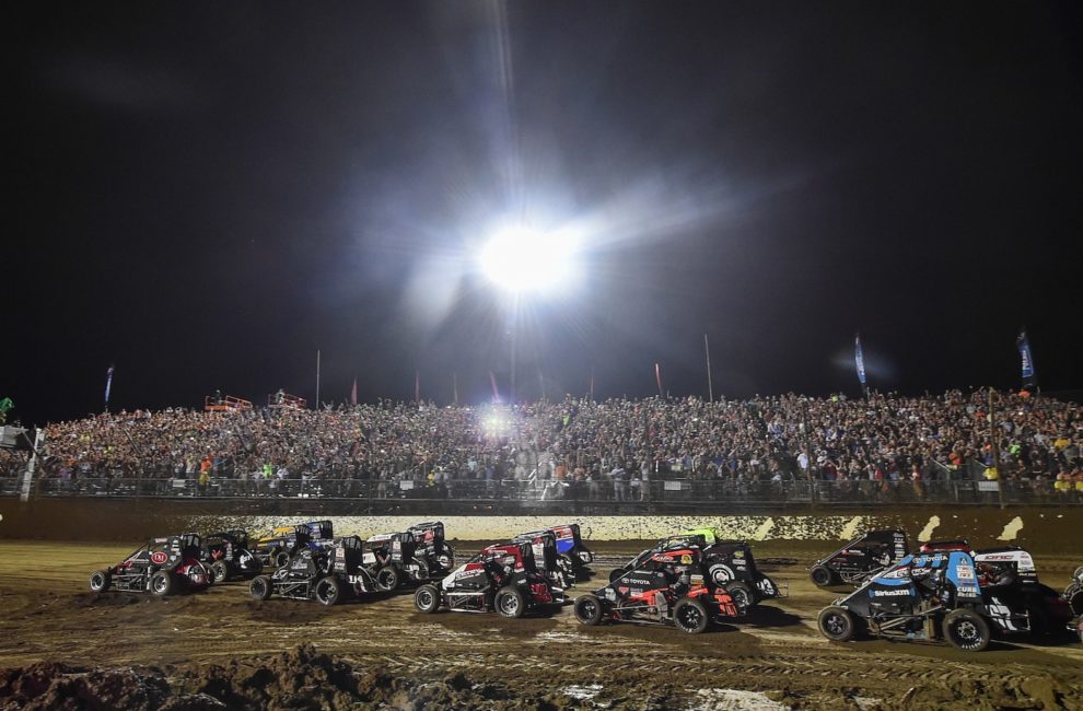 Cars race around the dirt track at Indianapolis Motor Speedway